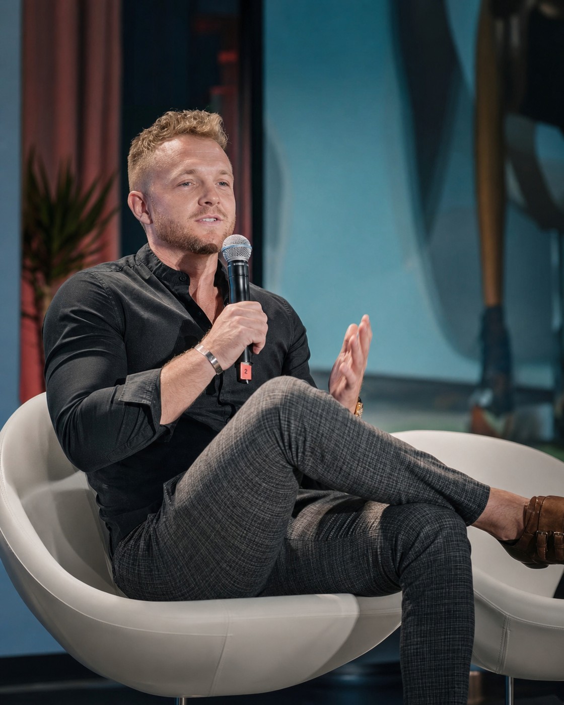 Joshua Barnes, founder of QuantumX Technologies, speaking on stage